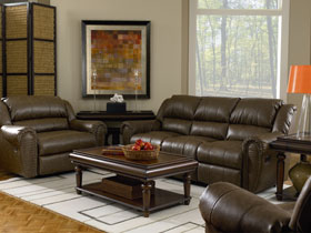 Living room with brown leather furniture arranged around a wooden coffee table.