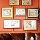 Many pieces of wall art haning on a Living Room wall.